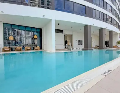 a large blue swimming pool in a building at City Skyline Views & Rooftop Pool at District 225 in Miami