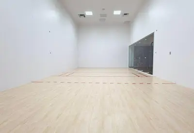 an empty white room with a wooden floor and a mirror at City Skyline Views & Rooftop Pool at District 225 in Miami