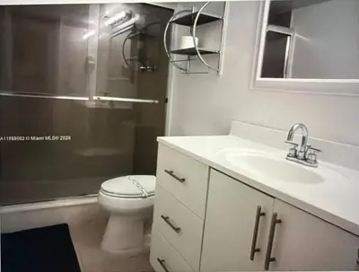 a bathroom with a toilet and a sink and a shower at Beautiful Apartment in Sunny Isles Beach in Sunny Isles Beach