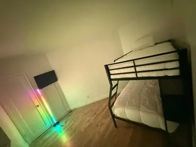 a bedroom with a bunk bed with a rainbow light at Beautiful Apartment in Sunny Isles Beach in Sunny Isles Beach
