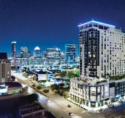 a city skyline at night with a large building at Lauderdale Breeze Villas in Fort Lauderdale