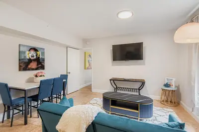 a living room with a blue couch and a table at Lauderdale Breeze Villas in Fort Lauderdale