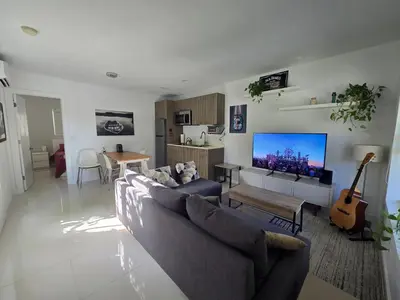 a living room with a couch and a flat screen tv at West Ave in Miami Beach