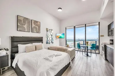 a bedroom with a bed and a table with chairs at Bay Views Studio in Miami