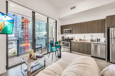 a living room with a couch and a kitchen at Bay Views Studio in Miami