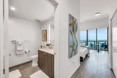 a bathroom with a sink and a toilet and a bedroom at Bay Views Studio in Miami