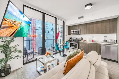 a living room with a white couch and a tv at Sublime Views Studio in Miami