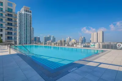 a large swimming pool on the roof of a building at Sublime Views Studio in Miami