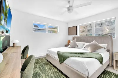 a bedroom with a bed and two windows at Palm Fiction - Pool and Hard Rock Casino in Hollywood