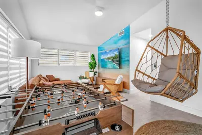 a living room with a foosball game at Palm Fiction - Pool and Hard Rock Casino in Hollywood