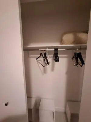 a closet with several pairs of shoes on a shelf at Amazing view day & night doral in Miami