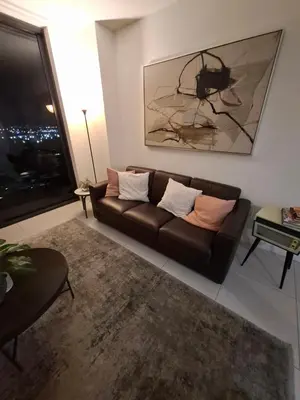 a living room with a couch and a picture of a spider at Amazing view day & night doral in Miami