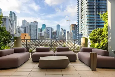 a balcony with couches and a view of a city at 4612 High-Floor Studio w Skyline View and a 24-hour Gym in Downtown Miami in Miami