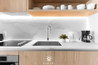 a kitchen with a sink and a counter top at High Rise Haven with Pool Cowork & Spa in Miami in Miami