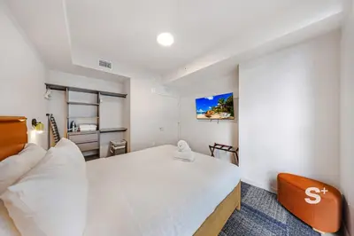 a bedroom with a white bed and a couch at Luxurious & Stylish 2BD Apt in Miami Gym & Pool in Miami