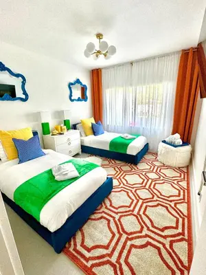 a bedroom with two beds and a rug at Delano in Fort Lauderdale