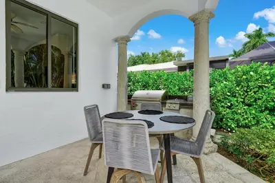 a table and chairs on the patio of a house at WATERFRONT MANSION Las Olas in Fort Lauderdale