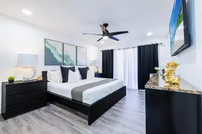 a bedroom with a bed and a ceiling fan at West Kendall Retreat Everglades Miccosukee in Hammocks