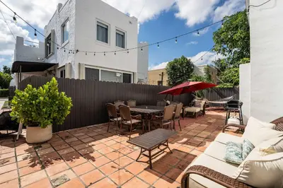 a patio with a table and chairs and a fence at Mar & Luna Family retreat in Miami