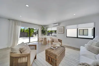a living room with a couch and a table at Waterfront Unit #2 20 Min Walk to Beach and Shops in Fort Lauderdale