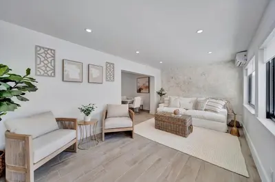 a living room with a couch and chairs and a table at Waterfront Unit #3 20 Min Walk to Beach and Shops in Fort Lauderdale