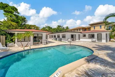 a swimming pool in front of a house at Waterfront Unit #5 20 Min Walk to Beach and Shops in Fort Lauderdale