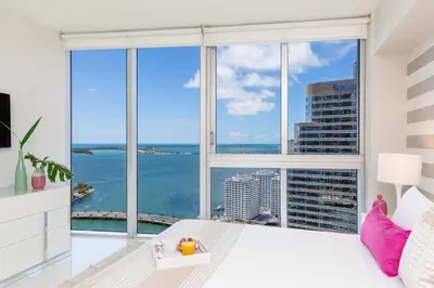 a bedroom with a large window with a view of the ocean at MVR - Luxury Stay by Brickell Center in Miami