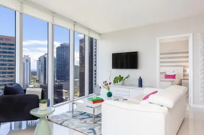 a living room with white furniture and large windows at MVR - Luxury Stay by Brickell Center in Miami