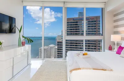 a bedroom with a large window with a view of the ocean at MVR - Luxury Stay by Brickell Center in Miami