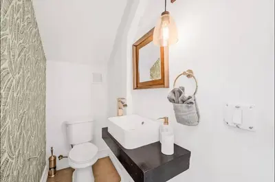 a bathroom with a white toilet and a sink at Sunny Miami Escape in Prime Location