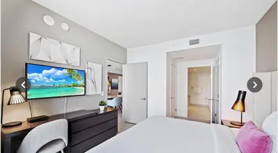 a bedroom with a bed and a tv on a wall at Hyde house 3507 AL MAR in Hollywood