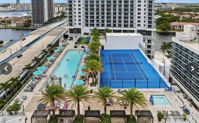an overhead view of a pool with a tennis court at Hyde house 3507 AL MAR in Hollywood