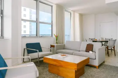 a living room with a couch and a table at 2BR Condos Circ Hotel by Hosteeva in Hollywood