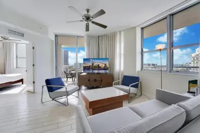 a living room with a couch and chairs and windows at 2BR Condos Circ Hotel by Hosteeva in Hollywood