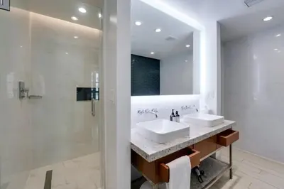 a bathroom with two sinks and a shower at 2BR Condos Circ Hotel by Hosteeva in Hollywood