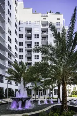 a large white building with palm trees in front of a fountain at 2BR Condos Circ Hotel by Hosteeva in Hollywood