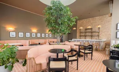 a restaurant with tables and chairs and plants at The Crosby Miami Worldcenter by Palermo Home Miami in Miami