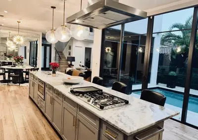 a kitchen and living room with a stove top oven at Luxury Gem in Fort Lauderdale