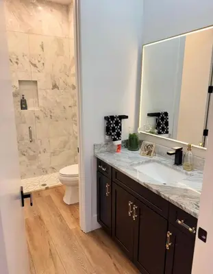 a bathroom with a sink and a toilet and a mirror at Luxury Gem in Fort Lauderdale