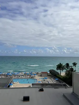 a view of a swimming pool and the ocean at Direct Ocean View Condo,Balcony kitchen pool gym sauna valet parking direct beach access for perfect vacation in Sunny Isles Miami in Sunny Isles Beach