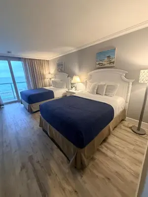 a hotel room with two beds and a window at Direct Ocean View Condo,Balcony kitchen pool gym sauna valet parking direct beach access for perfect vacation in Sunny Isles Miami in Sunny Isles Beach