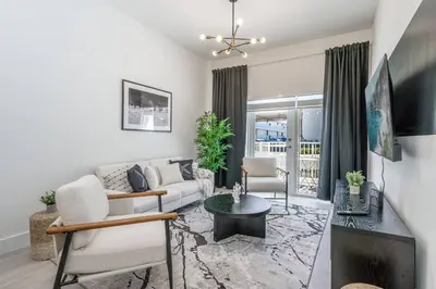 a living room with a couch and a table at Classy 2BR-2BA Oasis Beach Pool Parking EV Station in Hallandale Beach