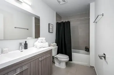 a bathroom with a sink and a toilet and a shower at Classy 2BR-2BA Oasis Beach Pool Parking EV Station in Hallandale Beach
