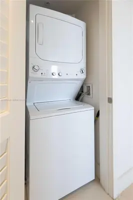 a television sitting on top of a refrigerator at Oceanfront dream W pool & beach access in Hollywood