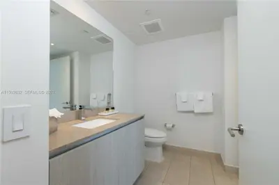 a white bathroom with a sink and a toilet at Oceanfront dream W pool & beach access in Hollywood