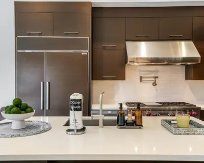 a kitchen with a counter with a mixer and a bowl of fruit at The Rendez-Vous Villa Waterfront in Fort Lauderdale