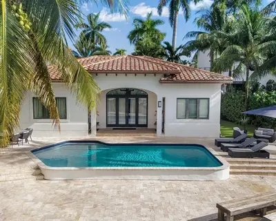 a house with a swimming pool in front of a house at The Rendez-Vous Villa Waterfront in Fort Lauderdale