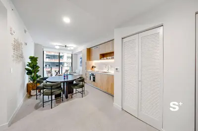 a kitchen and dining room with a table and chairs at Cozy Ensuite 1BR Apartment in DTW Miami in Miami