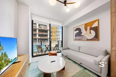a living room with a couch and a table at Cozy Ensuite 1BR Apartment in DTW Miami in Miami