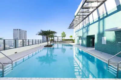 a swimming pool on the roof of a building at Central Downtown Condo with Pool & Gym in Miami